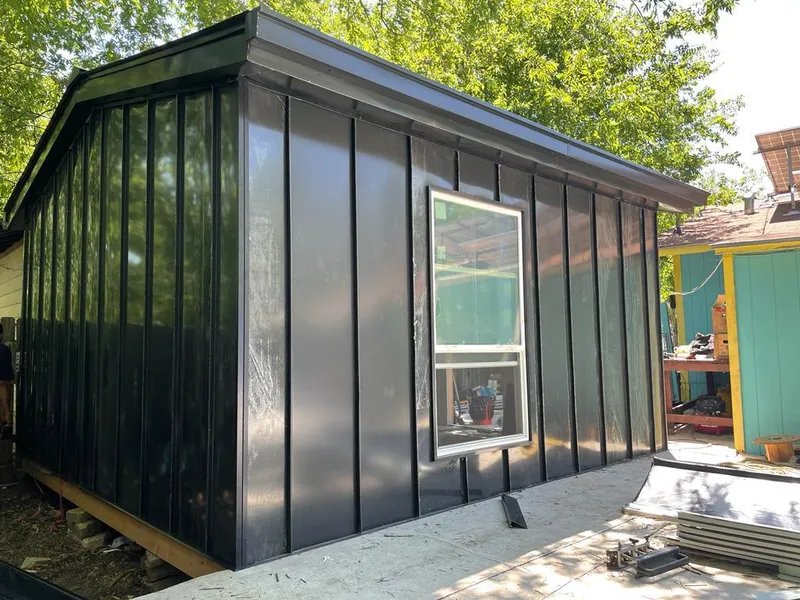 Black standing seam metal wall panels for Roof Inspection in St. Ann