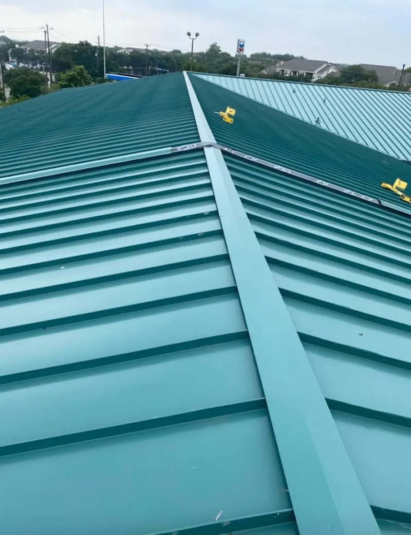 Green commercial metal roof ridge and valley for Metal Roof Repair in St. Ann